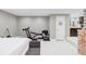 Finished basement with exercise equipment, a bed, and access to the kitchenette at 680 S Ogden St, Denver, CO 80209