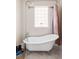 Bright bathroom featuring a clawfoot tub and chrome shower fixture at 680 S Ogden St, Denver, CO 80209