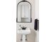 Elegant pedestal sink featuring a decorative mirror and black accents at 680 S Ogden St, Denver, CO 80209