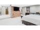 Spacious basement bedroom with brick accent wall, tv, walk-in closet, and modern furnishings at 680 S Ogden St, Denver, CO 80209
