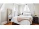 Bright bedroom with natural light featuring hardwood floors, white curtains and comfy bed at 680 S Ogden St, Denver, CO 80209