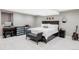 Finished basement bedroom with white woodgrain floors, large bed, and vanity at 680 S Ogden St, Denver, CO 80209
