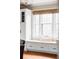 Close-up of a dining area featuring a window bench seat with custom storage at 680 S Ogden St, Denver, CO 80209
