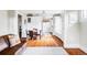 Sun-lit dining area with hardwood floors, custom built-ins, and a view into the kitchen at 680 S Ogden St, Denver, CO 80209