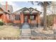 Charming brick home with inviting front porch and professionally landscaped front yard at 680 S Ogden St, Denver, CO 80209