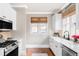 Bright kitchen with white cabinetry, stainless steel appliances, and hardwood floors at 680 S Ogden St, Denver, CO 80209