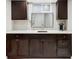 Basement kitchenette features modern cabinets, a white countertop, and an under-mount sink at 680 S Ogden St, Denver, CO 80209
