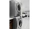 Laundry area with a modern stacked washer and dryer and access to the bedroom area at 680 S Ogden St, Denver, CO 80209