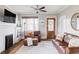 Cozy living room featuring a decorative fireplace, wooden floors, and comfortable leather seating at 680 S Ogden St, Denver, CO 80209