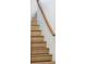 Carpeted Staircase with stained handrail and white walls at 680 S Ogden St, Denver, CO 80209