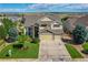 Aerial view of a beautiful home with a three-car garage, manicured lawn, and well-maintained landscaping at 4864 Harness Ct, Parker, CO 80134