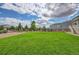 Spacious backyard with a well-maintained lawn and wooden fence, providing a serene and private outdoor space at 4864 Harness Ct, Parker, CO 80134