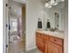 Bathroom view showing the vanity with wood cabinets, and view to the bath and toilet at 4864 Harness Ct, Parker, CO 80134