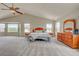 A large bedroom with lots of windows, furniture, and carpeted floors at 4864 Harness Ct, Parker, CO 80134