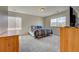 Well-lit bedroom with large windows and natural light, complete with cozy carpet flooring at 4864 Harness Ct, Parker, CO 80134