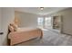 Inviting bedroom with two windows, a built-in bookcase, and neutral carpet flooring at 4864 Harness Ct, Parker, CO 80134