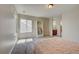 Bright bedroom with two windows, neutral walls, and a charming bookcase near the bed at 4864 Harness Ct, Parker, CO 80134