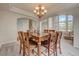 Bright dining room boasts a large window, chandelier, and elegant staircase at 4864 Harness Ct, Parker, CO 80134