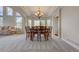 Elegant dining room with large windows, modern chandelier, and direct access to the living room at 4864 Harness Ct, Parker, CO 80134