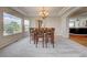 Bright dining room features a tray ceiling, view and an elegant chandelier at 4864 Harness Ct, Parker, CO 80134
