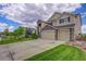 Two-story home featuring stone accents, well-maintained lawn, a three-car garage and landscaped yard at 4864 Harness Ct, Parker, CO 80134