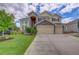 Charming two-story home with a three-car garage, stone accents, and well-manicured front yard at 4864 Harness Ct, Parker, CO 80134