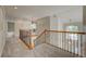 Beautiful hallway with carpet and wood and metal stair railing at 4864 Harness Ct, Parker, CO 80134