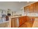 Updated kitchen has wood cabinets and opens to the living room at 4864 Harness Ct, Parker, CO 80134