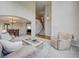 Inviting living room with soaring ceilings, a glimpse of dining and staircase, and comfortable seating at 4864 Harness Ct, Parker, CO 80134