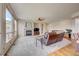 Living room features fireplace, ceiling fan and large windows with natural light at 4864 Harness Ct, Parker, CO 80134