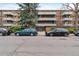 Apartment building exterior showing brick facade, balconies, and tree lined street at 2500 S York St # 204, Denver, CO 80210