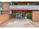 Building entrance showing covered walkway and brick facade and glass door at 2500 S York St # 204, Denver, CO 80210