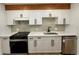 Updated kitchen with white cabinets, quartz countertops, stainless appliances, and stylish backsplash for a modern look at 2500 S York St # 204, Denver, CO 80210