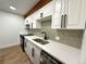 Modern kitchen featuring stainless steel appliances and quartz countertops, accented by a decorative backsplash at 2500 S York St # 204, Denver, CO 80210