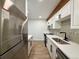 Modern kitchen featuring stainless steel appliances and quartz countertops, accented by a decorative backsplash at 2500 S York St # 204, Denver, CO 80210