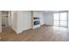 Inviting living room with wood-style flooring, electric fireplace, and a sliding glass door to the balcony at 2500 S York St # 204, Denver, CO 80210