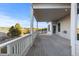 View from back porch with white railings and columns and view of trees and pasture at 34427 Columbine W Trl, Elizabeth, CO 80107