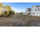 Expansive back yard with natural grasses and rear view of house with back porch at 34427 Columbine W Trl, Elizabeth, CO 80107