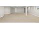 Open basement with light gray carpet, white walls, and support beams offering a versatile, unfinished space at 34427 Columbine W Trl, Elizabeth, CO 80107