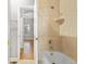 Bathroom featuring tile walls, a white bathtub, and a showerhead for comfortable bathing experience at 34427 Columbine W Trl, Elizabeth, CO 80107