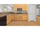 Well-equipped kitchen featuring wooden cabinets, granite countertops, and modern appliances at 34427 Columbine W Trl, Elizabeth, CO 80107