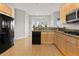 Well-lit kitchen with wood cabinets, granite counters, and stainless steel appliances, adjacent to a bay window breakfast nook at 34427 Columbine W Trl, Elizabeth, CO 80107