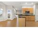 Open kitchen with wooden cabinets, granite countertops, and stainless steel microwave at 34427 Columbine W Trl, Elizabeth, CO 80107