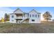 Rear exterior of home with white trim, back porch and stairs to ground level at 34427 Columbine W Trl, Elizabeth, CO 80107