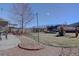 Large backyard featuring a trampoline, swing set, and a stone garden at 5683 Raleigh Cir, Castle Rock, CO 80104