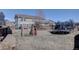 Wide backyard featuring play structure, trampoline, patio, and privacy fence at 5683 Raleigh Cir, Castle Rock, CO 80104
