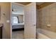 Ensuite bathroom with shower over tub visible from the bedroom at 5683 Raleigh Cir, Castle Rock, CO 80104
