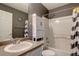 Modern bathroom featuring a shower-tub combo and stylish grey decor at 5683 Raleigh Cir, Castle Rock, CO 80104