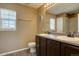 Well-lit bathroom features a double sink vanity and a window with natural light at 5683 Raleigh Cir, Castle Rock, CO 80104