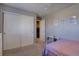 Cozy bedroom featuring closet, shelving unit, and minimalist decor at 5683 Raleigh Cir, Castle Rock, CO 80104
